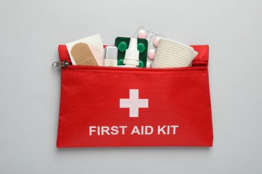 First aid kit on gray background, top view