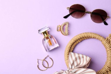 Bag and stylish accessories on lilac background, flat lay. Space for text