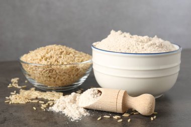 Kahverengi pirinç ve un gri masada, yakın plan.