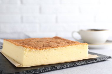 Tasty Japanese Castella sponge cake served on light table, closeup. Space for text