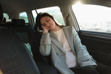 Modern arabasında uyumaktan yorgun düşmüş.