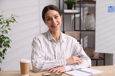 Gülümseyen çevrimiçi hoparlör. İçerideki masada web kamerasından görüntüsü olan webinar.