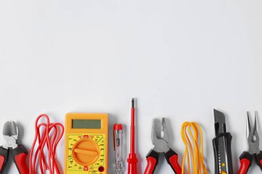 Different electrical tools on light background, flat lay. Space for text