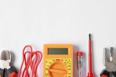 Different electrical tools on light background, flat lay. Space for text