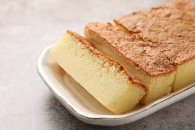 Tasty Japanese Castella sponge cake on light table, closeup