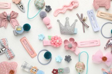 Different hair accessories on white table, flat lay