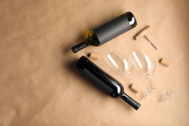 Şarap şişeleri, bardaklar, tirbuşon ve parşömen kağıdındaki mantarlar, düz yatak. Metin için boşluk