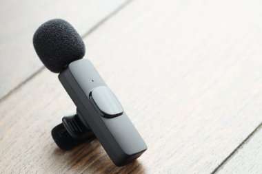 Lavalier mikrofonu ahşap masada, yakın plan. Metin için boşluk