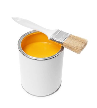 Can of yellow paint and brush isolated on white