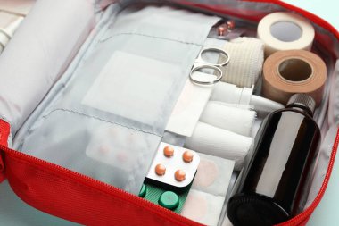 İlk yardım çantası. Masada farklı tıbbi malzemeler var, yakın plan.