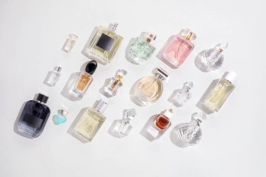 Hafif arka planda çeşitli parfüm şişeleri, düz yatıyordu.