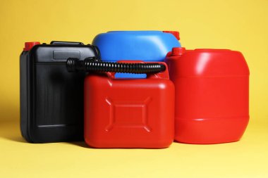 Many different plastic canisters on yellow background
