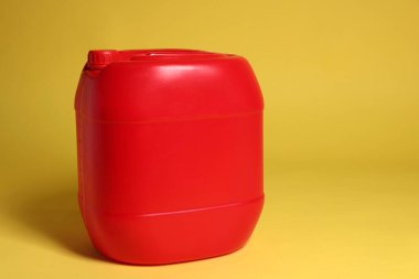Sarı arkaplanda bir kırmızı plastik kutu, metin için boşluk