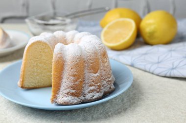 Açık dokulu masaya pudra şekerli lezzetli limonlu pasta, yakın plan.