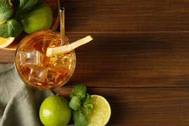 Buzlu çayı limon dilimi, kireç ve nane şekeri ile ahşap masaya seriyorum. Metin için boşluk