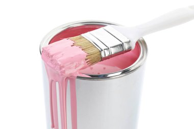 Can of pink paint and brush isolated on white