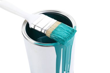 Can of turquoise paint and brush isolated on white