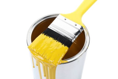 Can of yellow paint and brush isolated on white