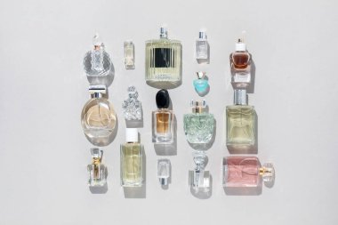 Bej arka planda çeşitli parfüm şişeleri, düzlük