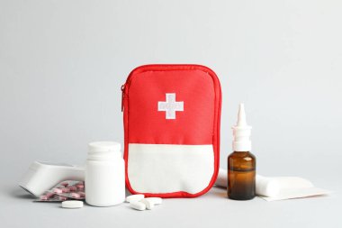 First aid kit. Different medical supplies on light grey background