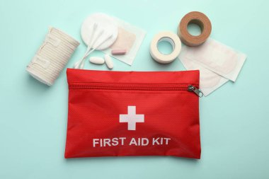 First aid kit. Different medical supplies on light blue background, flat lay