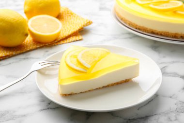 Lezzetli limonlu cheesecake ve çatal beyaz mermer masada, yakın plan.