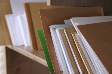 Postanedeki raflarda farklı zarflar, yakın çekim. Metin için boşluk