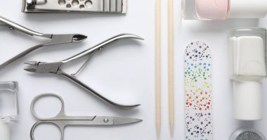 Beyaz arkaplanda farklı manikür araçları kümesi, düz yatıyordu