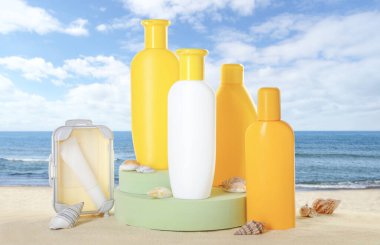 Deniz kenarındaki kumlu sahilde güneş kremi ürünleri. Podyum ve deniz kabukları ile şık bir sunum