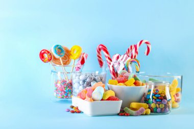 Candy bar. Many different sweets on light blue background. Space for text