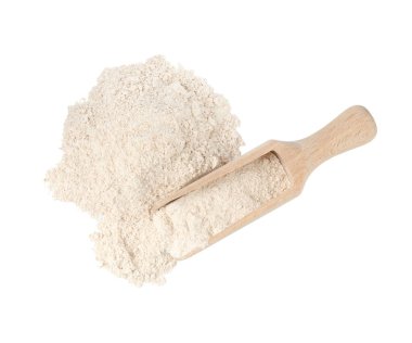 Pile of brown rice flour and scoop isolated on white, top view