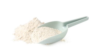 Pile of brown rice flour and scoop isolated on white