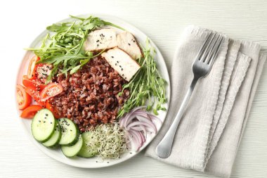 Beyaz ahşap masada kahverengi pirinçli nefis bir salata.