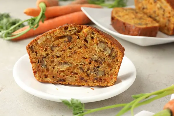 Açık gri masada fındıklı ve sebzeli ev yapımı havuçlu kek, yakın plan.