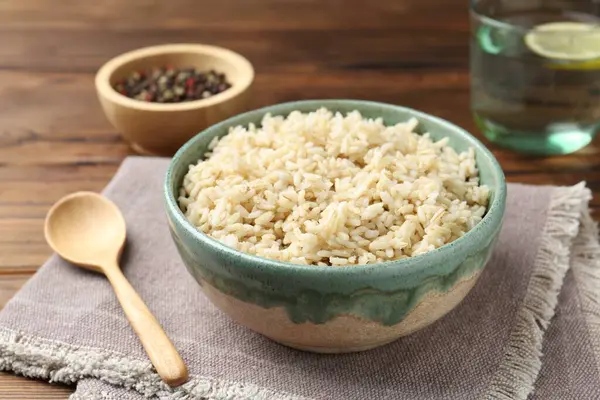 Tahta masada servis edilen lezzetli kahverengi pirinç, yakın plan.