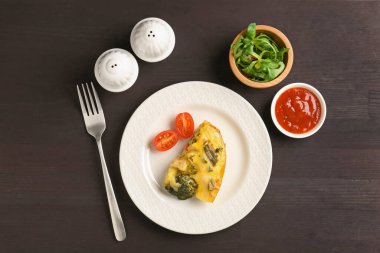 Siyah ahşap masada servis edilen lezzetli sebze güveci.