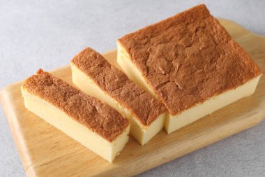 Tasty Japanese Castella sponge cake on light table, closeup