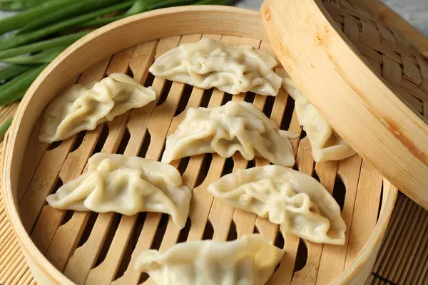 Bambu buharlı tencerede kaynamış gyoza (hamur tatlısı), yakın plan.