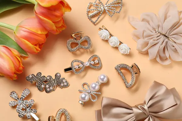 Güzel saç tokaları, bej arka planda fiyonk ve laleler.