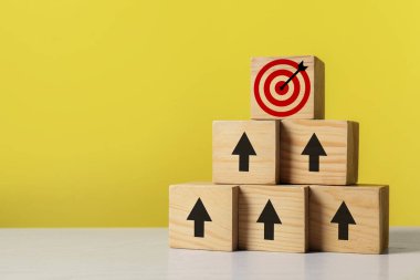 Hedef alınıyor. Sarı arkaplan üzerinde hedef tahtası olan küpler piramidi.