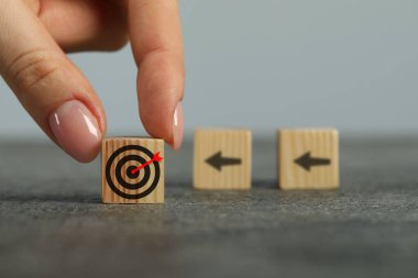 Hedef alınıyor. Masada okları olan diğer kadınlara gözleriyle küp atan kadın, yakın plan.