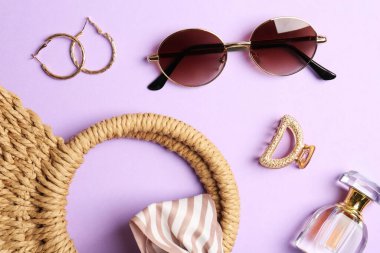 Bag and stylish accessories on lilac background, flat lay