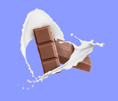 Lezzetli çikolata parçaları ve renkli arka planda havaya sütün damlaları