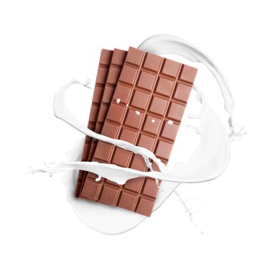 Nefis çikolatalar ve beyaz arka planda havadaki süt damlaları