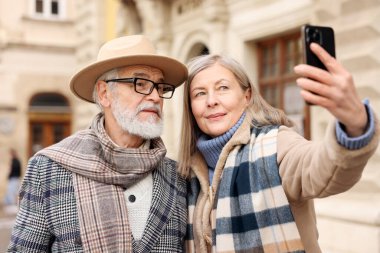 Güzel yaşlı çift şehirde selfie çekiyor.