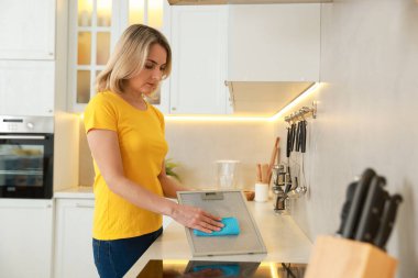 Mutfak kaputunun filtresi kapalı alanda paçavralarla temizleniyor.