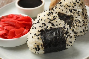 Pirinç topları (onigiri), soya sosu ve tabakta turşulu zencefil, yakın plan. Geleneksel Japon yemeği