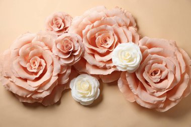 Bej arka planda güzel kağıt çiçekler, düz uzanmış