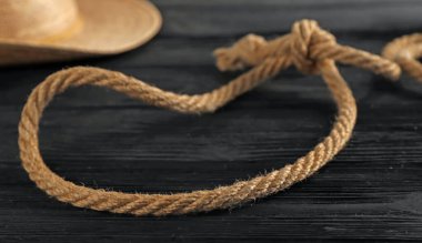 Siyah ahşap arka planda pamuktan yapılmış kement, yakın plan.