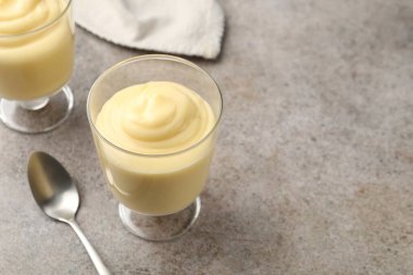 Gri masada servis edilen lezzetli vanilyalı puding. Metin için boşluk